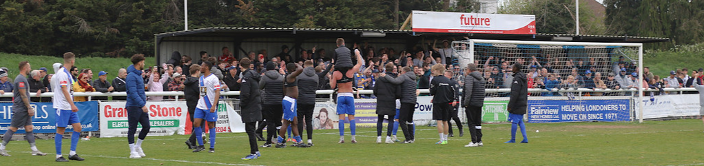 Town fans & players celebrate together following a win
