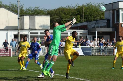 Billericay keeper Alan Julian beats Ricky Gabriel to a cross