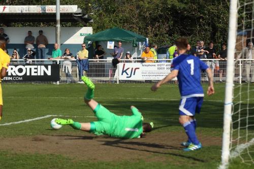 Billericay keeper Alan Julian saves, but can only push the ball to Harry Ottaway who put Enfield 2-1 ahead