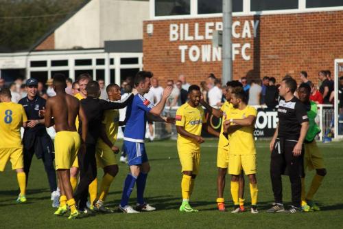 Billericays Joe Ellul (blue) congratulates the Enfield team at the final whistle