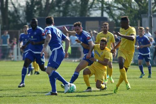 Billericays Matt Johnson (blue, R) barges Tyler Campbell off the ball