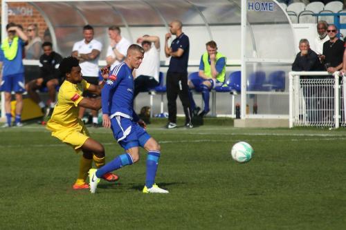 Billericays Paul Konchesky (blue) plays the ball back under pressure from Dernell Wynter