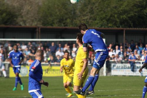 Billericays Rob Swaine (R) heads clear from Harry Ottaway