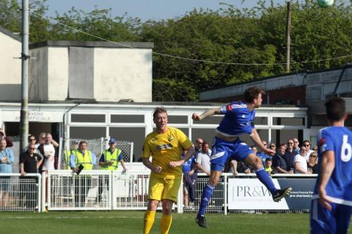 Billericays Rob Swaine (blue) heads clear from Mark Kirby