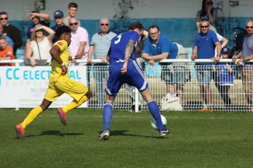 Billericays Rob Swaine clears from Dernell Wynter