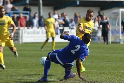 Billericays Tambeson Eyong (blue) blocks from Scott Shulton
