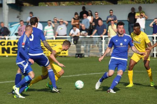 Enfields Billy Crook (yellow, R) tries to wriggle his way into the penalty area