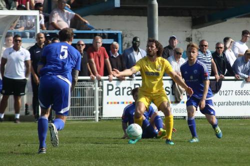 Enfields Harry Ottaway (yellow) appeals for a free kick