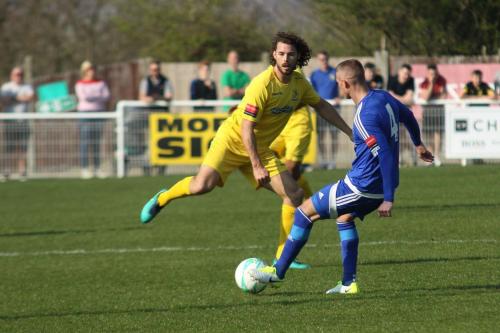 Enfields Harry Ottaway (yellow) tries to close down Paul Konchesky