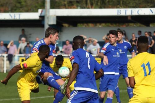 Enfields Ricky Gabriel (yellow, L) and Harold Joseph challenge at a set piece