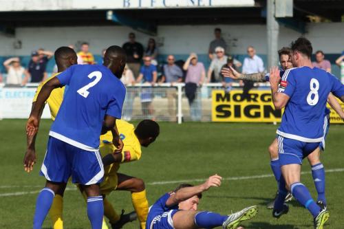 Enfields Ricky Gabriel (yellow, R) tries to get a shot through the defence