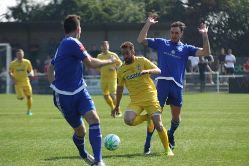 Enfields Scott Shulton (yellow) challenged by Matt Johnson (R) and Joe Ellul