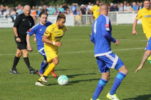 Enfields Tyler Campbell (yellow) chased by Lewis Taafe
