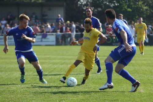 Enfields Tyler Campbell (yellow) runs between Byron Lawrence (L) and Joe Ellul