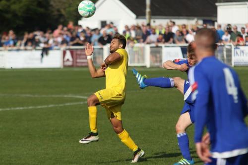 Enfields Tyler Campbell (yellow) tries to block a clearance from Byron Lawrence