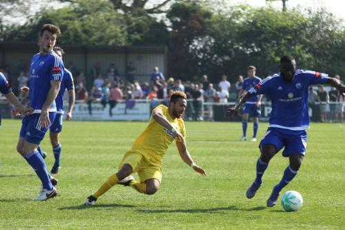 Enfields Tyler Campbell goes down after having his heels clipped by joe Ellul (L)