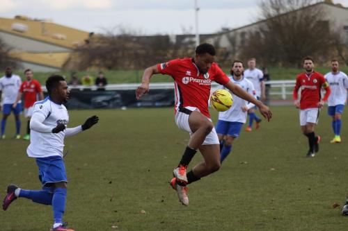 Burgess Hills Cheick Toure (red) controls the ball