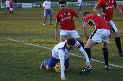 Enfields Billy Crook (white) challenged by Toby Pointing