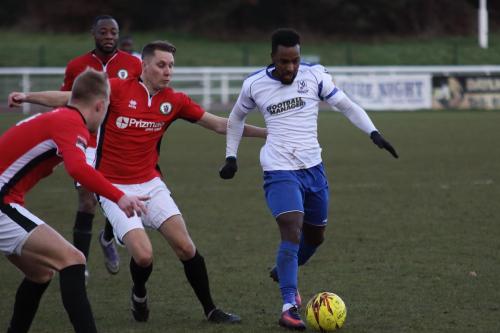 Enfields Bobby Devyne challenged by James Richmond (L) and Toby Pointing