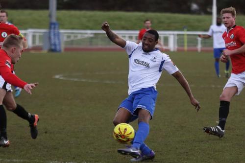 Enfields Ricky Gabriel shoots against the arm of a Burgess Hill defender  The referee waved away appeals for a penalty