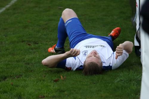 Enfield captain Mark Kirby feels the effects of a collision with the perimeter fencing