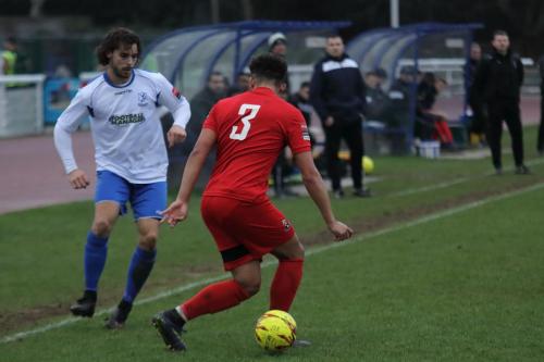 Enfields Harry Ottaway (L) plays the ball through Aidan Austins legs