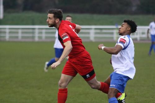 Sudburys Adam Tann (red) heads clear from Dernell Wynter