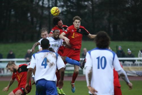 Sudburys Tyler French (red, R) and James Baker beat Ricky Gabriel (who appears to have headed Frenchs elbow) and Mark Kirby at a set piece