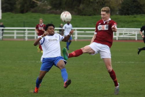 Bognors Chad Field (R) clears from Dernell Wynter