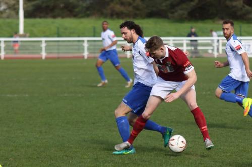 Bognors Chad Field (maroon) challenges Harry Ottaway