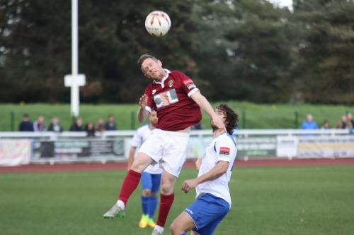 Bognors Darren Budd heads clear from Harry Ottaway