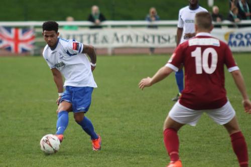 Nathan Livings plays the ball past Ollie Pearce