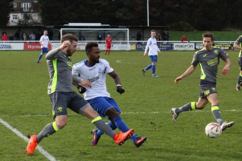Enfields Bobby Devyne crosses under challenge from Rory Williams (grey, L) watched by Wes Fogden