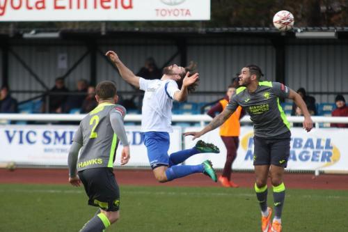 Enfields Harry Ottaway (white) flicks the ball over Jordan Rose