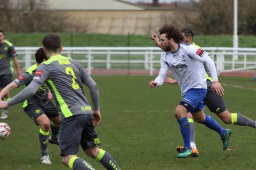 Enfields Harry Ottaway (white) runs at the Havant defence