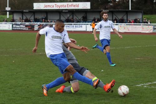 Enfields Jonathan Muleba (L) shoorts as Rory Williams tries to block