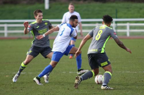 Enfields Tyler Campbell challenges by Wes Fogden (L) and Theo Lewis