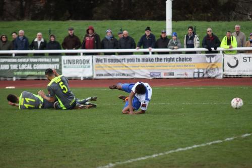 Having brought down Karl Oliyide, Jordan Rose (5) catches Bradley Tarbuck with his follow through
