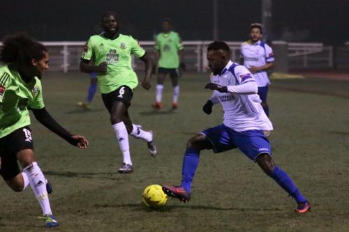 Enfields Bobby Devyne (R) runs at Kezie Ibe