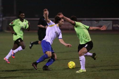 Enfields Harry Ottaway takes the ball past Luke Tingey (R)