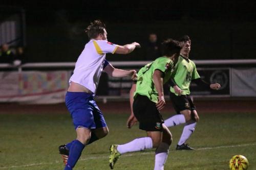 Enfields Mark Kirby (L) challenges Luke Tingey