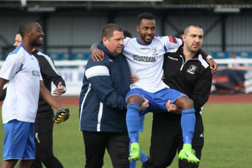Enfield golascorer Bobby Devyne, injured in the closing stages, is carried from the field