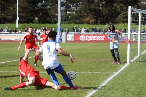 Enfields Dernell Wynter (9) crosses as Tom Bullard challenges