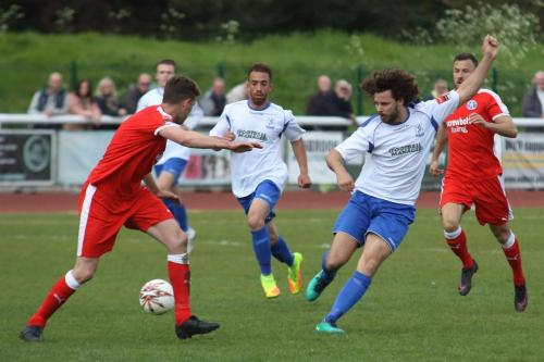 Enfields Harry Ottaway (white, R) plays the ball past Tom Bullard