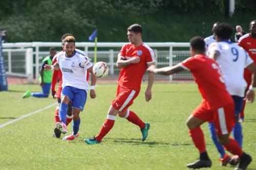 Enfields Tyler Campbell (L) plays the ball forwards