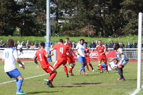 Leistons Jack Ainsley (4) clears a cross from Karl Oliyide