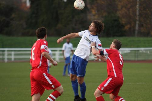 Enfields Harry Ottaway flicks a header over Sonny Miles (