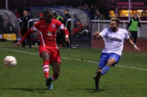 Enfields Tyler Campbell gets his cross away despite the challenge of James Folkes