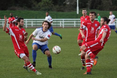 Harry Ottaway plays the ball between Nick Wheeler (L) and Jack Parter