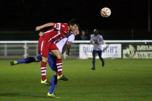 Tonbridges George Beavan (red) heads clear from Mark Kirby